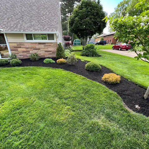 Mulched landscape beds beside a home