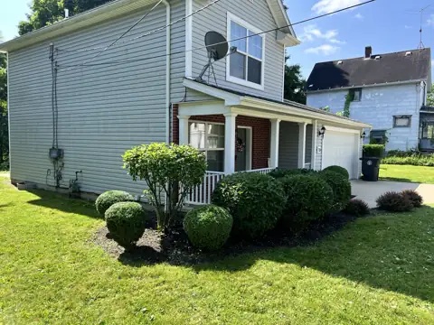Rounded and shaped shrubs around the front of a home